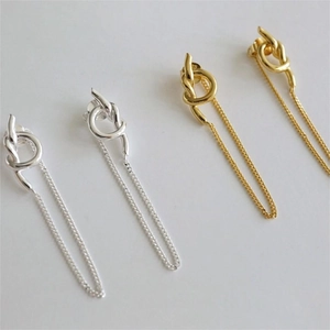 Detail showing the 925 silver hallmark and knot design on gold and silver chain earrings