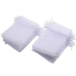 Stack of premium white sheer organza gift bags with satin drawstring closure