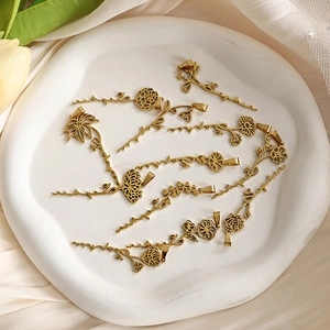 Detail of gold floral name pendants on a ceramic tray with warm decorative lighting