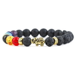 Macro view of lava stone chakra bracelet featuring golden elephant charm and alloy beads