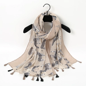 Detail view of beige zebra print scarf with stylish black and beige fringed tassels