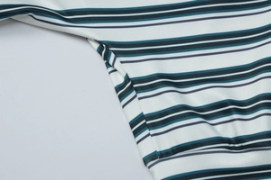 Detail view of high-quality stitching and fabric texture on a striped long-sleeve top