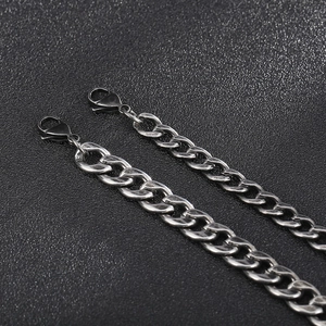Detail of vintage silver and gunmetal stainless steel curb chains with lobster clasps