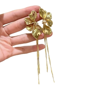 Golden flower tassel earrings with shimmering crystals and textured metallic petals