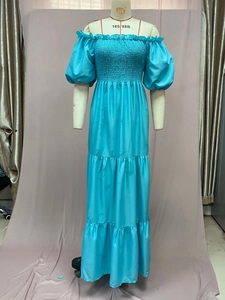 Detail of turquoise off-shoulder maxi dress with ruffled neckline and tiered skirt