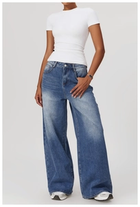 Macro detail of high-waist wide-leg denim jeans with classic wash and cat-whisker texture