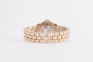 Détail du bracelet en métal or rose et du dos du boîtier poli de la montre à quartz pour femme