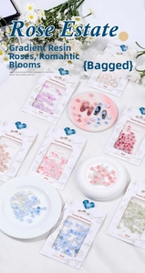 Detailed close-up of 3D resin rose nail art charms with pearls and colorful gradients