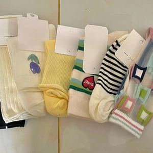 Set of five cute cotton socks with floral embroidery and colorful striped patterns