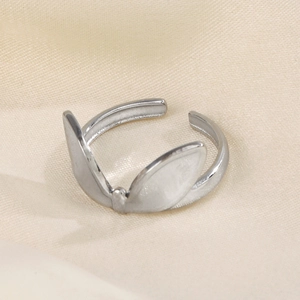 Adjustable silver bunny ear stainless steel ring on a beige textured fabric background