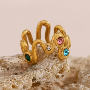 Detail of 18K gold plated wave ring with multicolored zircons on natural rock