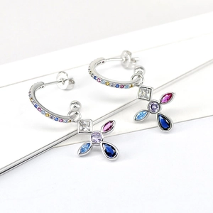 Macro shot of colorful zircon cross earrings made of S925 silver on white background