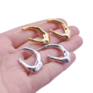 Detailed view of irregular geometric 18K gold and silver plated stainless steel earrings