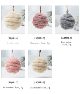 Detail of 6cm pink felt pom-poms with woven lanyards for Christmas tree decoration