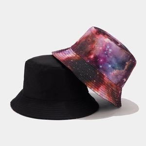Detail of reversible bucket hat showing both solid black and starry galaxy print patterns