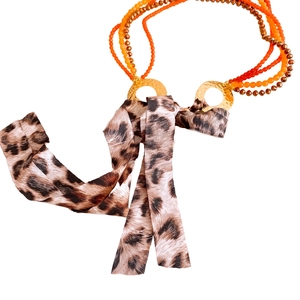 Bohemian multilayer necklace with orange glass beads, gold rings and leopard print ribbon