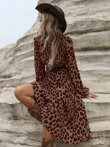 Close-up of leopard print maxi dress with brown waist belt and western boots