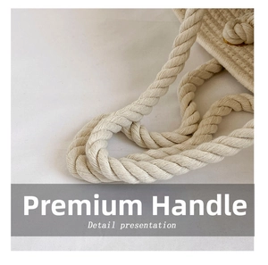 Macro detail of thick woven cotton handles on a handmade cream straw tote bag