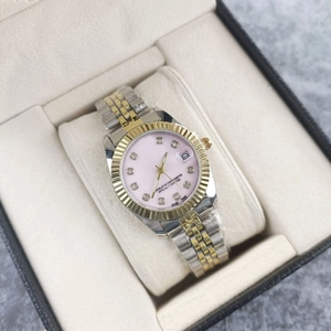 Detail of luxury two-tone women's watch with pink dial, diamond indices, and date window