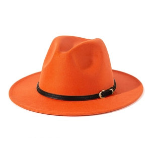 Detail of orange wool fedora with black leather band and golden metal buckle close-up