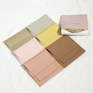 Macro shot of multiple PU leather jewelry pouches with snap buttons and inner protective pads