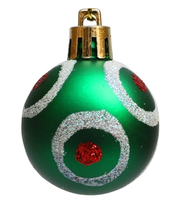 Detail of green Christmas ball with silver glitter circles and red centers on white background