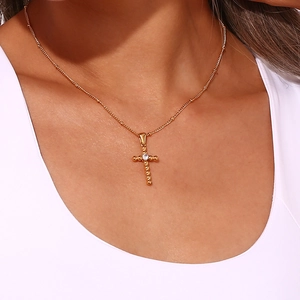 Detail of 18K gold-plated cross pendant necklace with zircon on a delicate bead chain