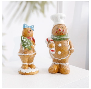 Close-up of resin gingerbread man figurines with chef hat and Christmas tree decor