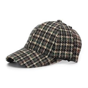 Detail view of the heavy wool houndstooth baseball cap showing classic British retro pattern