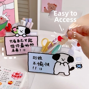 Close-up of cute acrylic desk organizer with cartoon puppy and pastel stationery