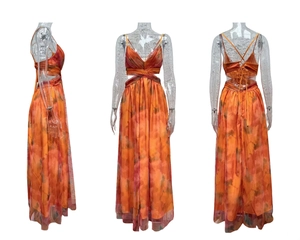 Detail of mesh maxi dress with orange tie-dye print, V-neck, and waist cut-out features