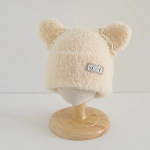 Detail of baby winter plush hat featuring cute bear ears and delicate lace trim