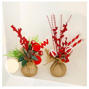 Close-up of rustic Christmas table decor with red berries, pine cones and burlap base