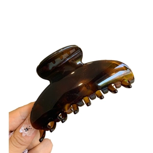 Brown tortoiseshell large hair claw clip in glossy resin for elegant hairstyling