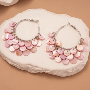 Bohemian style hoop earrings featuring pink shell discs and silver needles for beach vacation
