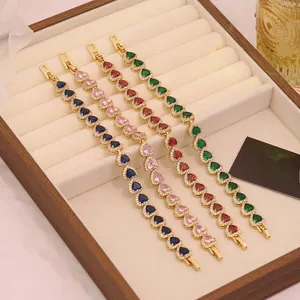 Detailed view of 18K gold plated heart bracelets with colorful zirconia in a jewelry box
