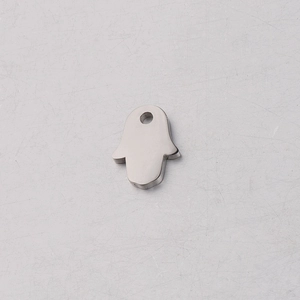 Detailed macro view of a silver mirror-polished stainless steel Hamsa Hand charm