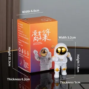 Astronaut figure in white and gold finish with orange gradient display box packaging