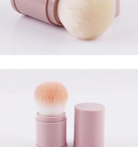 Detail view of the retractable pink makeup brush with soft gradient bristles and cap