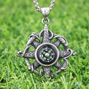 Macro detail of nautical compass pendant in vintage silver metal showing dimensions