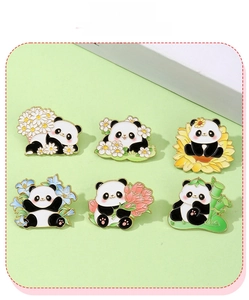 Detailed view of six panda enamel pins with flowers and bamboo on green background