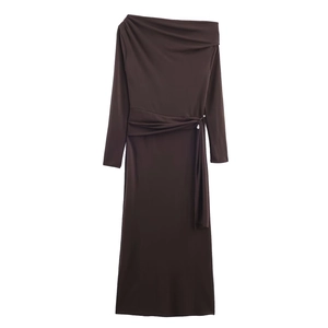 Brown long-sleeve maxi dress with asymmetric neckline and waist buckle detailing