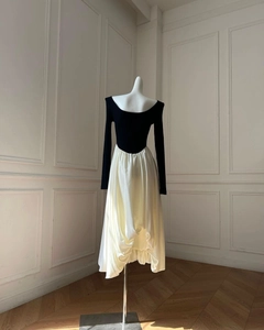 Detail of contrast patchwork dress showing knit bodice and satin flare hemline