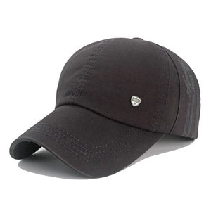 Detailed view of dark gray cotton twill baseball cap with silver metal fashion shield badge