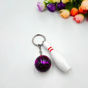 Miniature white bowling pin and black marble ball keychain with silver metal ring