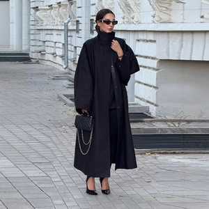 Chic black longline trench coat with high collar and oversized fit for street style