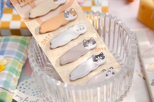 Close-up of cute cat-shaped index tabs in various colors on a desktop setting