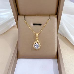 Elegant gold-tone teardrop necklace with white zircon pendant in a brown jewelry box