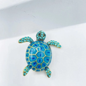 Vintage sea turtle brooch in gold metal with blue enamel and sparkling rhinestones