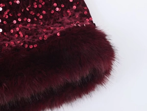 Detailed macro shot of burgundy velvet with sequins and plush faux fur trim detail